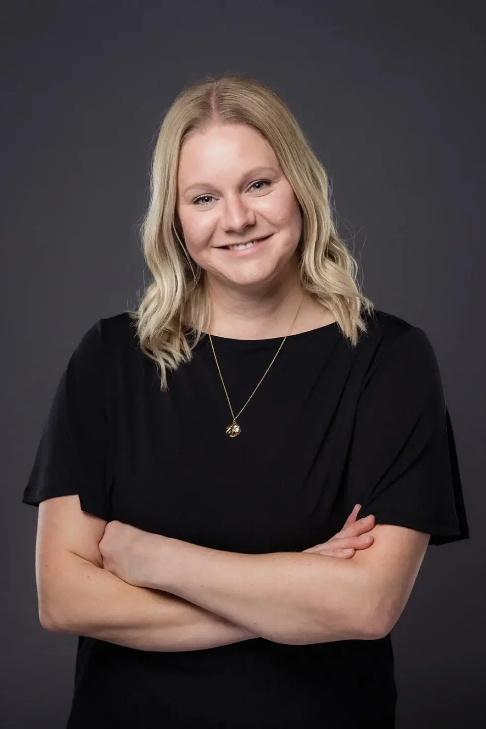 a woman in black dress posing for a picture